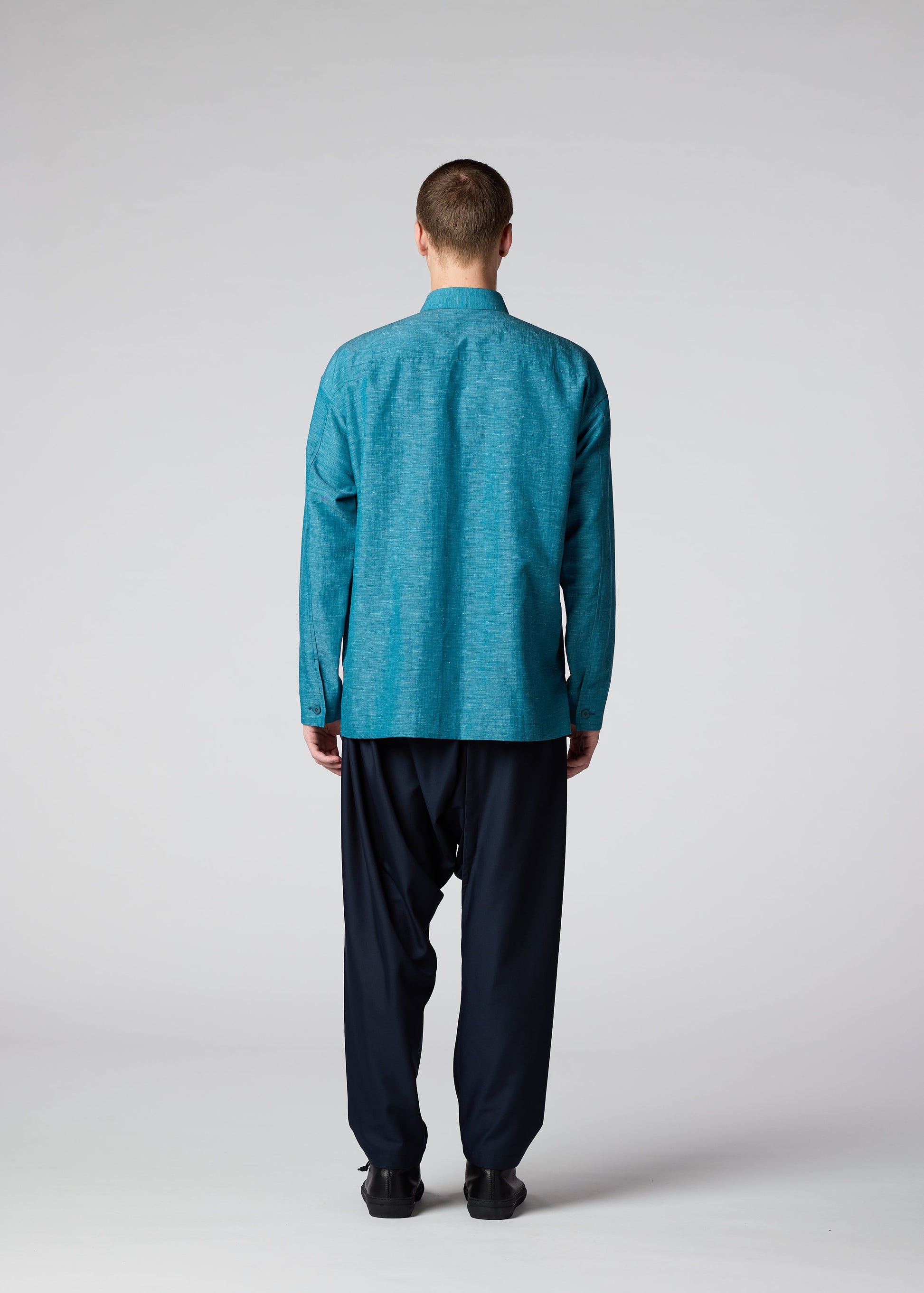 A model wears the IM MEN HYBRID SHIRT shirt.