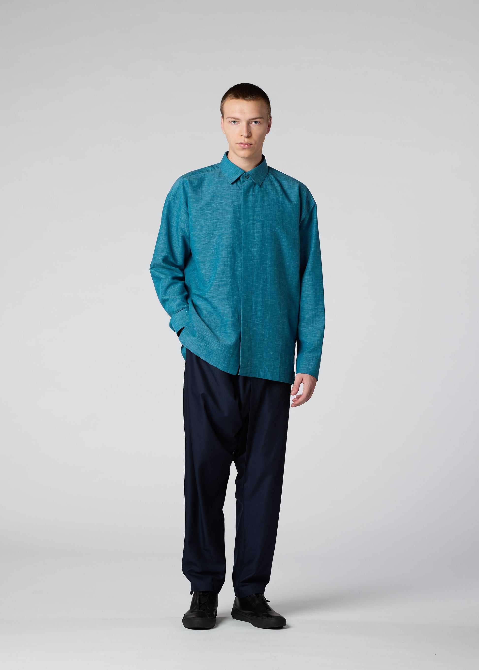 A model wears the IM MEN HYBRID SHIRT shirt.