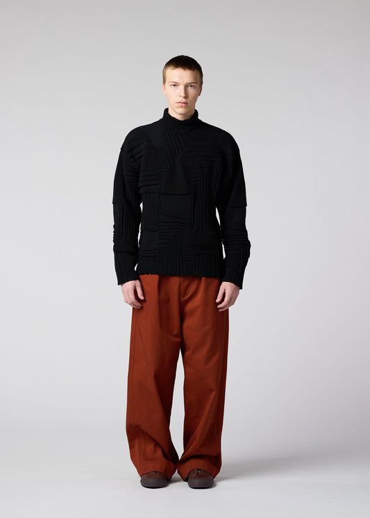 A model wears the IM MEN DEKOBOKO KNIT top.