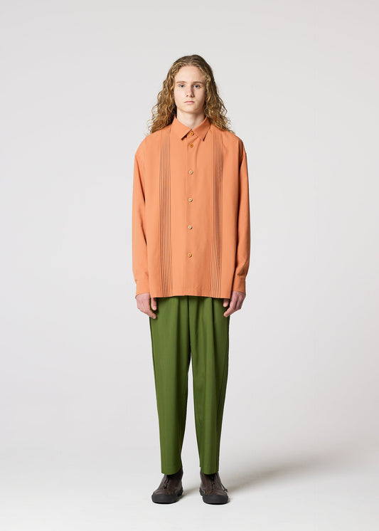 A model wears the IM MEN AIR PLEATS trousers.