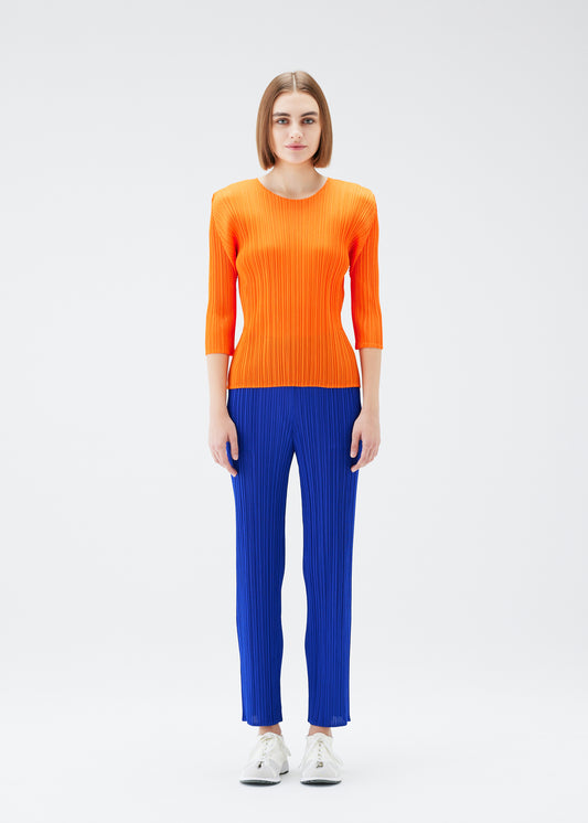 A model wears the PLEATS PLEASE ISSEY MIYAKE MONTHLY COLORS JULY trousers
