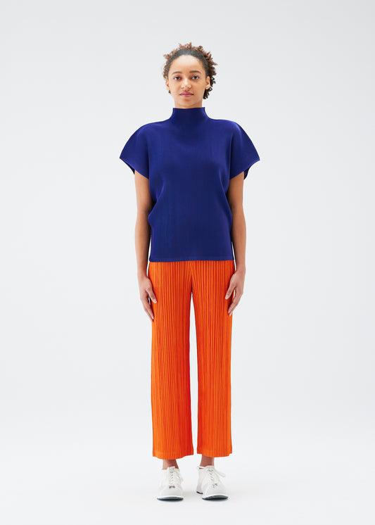 A model wears the PLEATS PLEASE ISSEY MIYAKE THICKER BOTTOMS 1 trousers