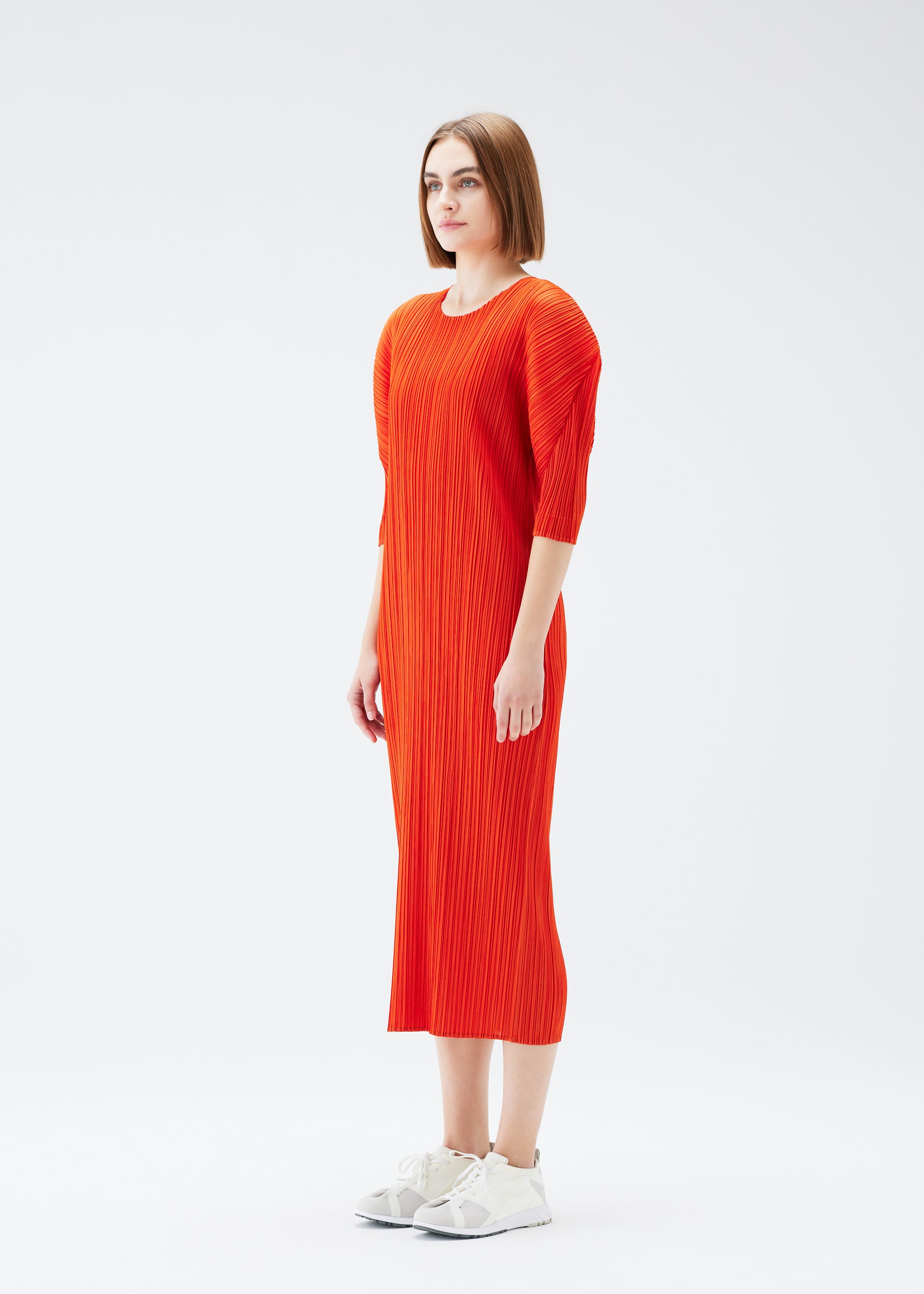 A model wears the PLEATS PLEASE ISSEY MIYAKE MONTHLY COLORS JULY dress