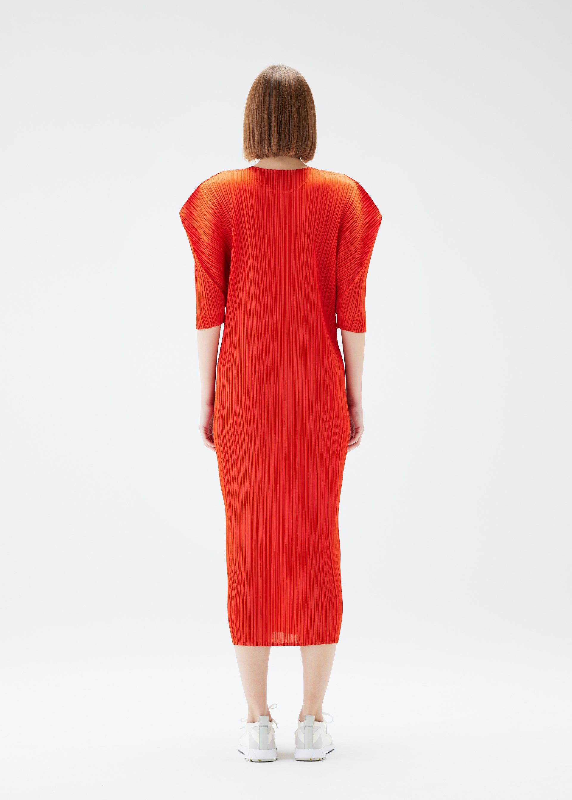A model wears the PLEATS PLEASE ISSEY MIYAKE MONTHLY COLORS JULY dress