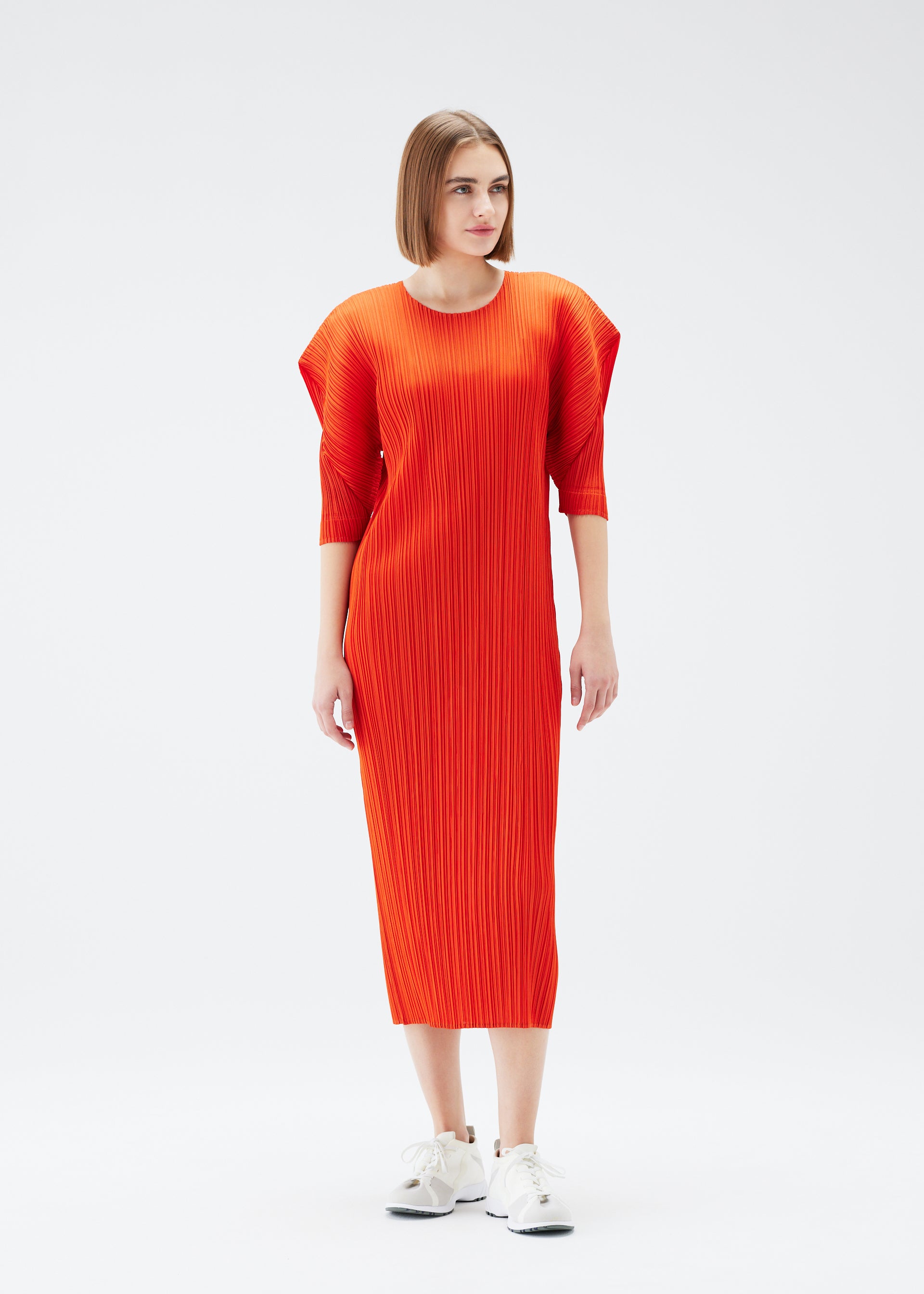 A model wears the PLEATS PLEASE ISSEY MIYAKE MONTHLY COLORS JULY dress