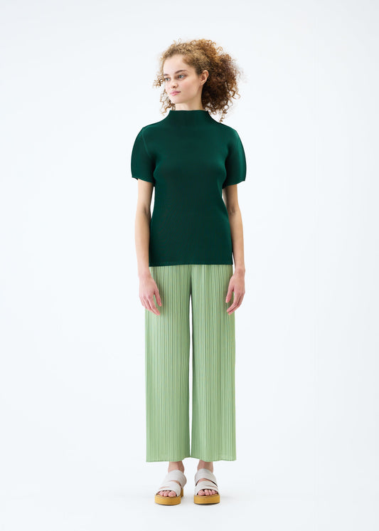 A model wears the PLEATS PLEASE ISSEY MIYAKE MIST JUNE top.