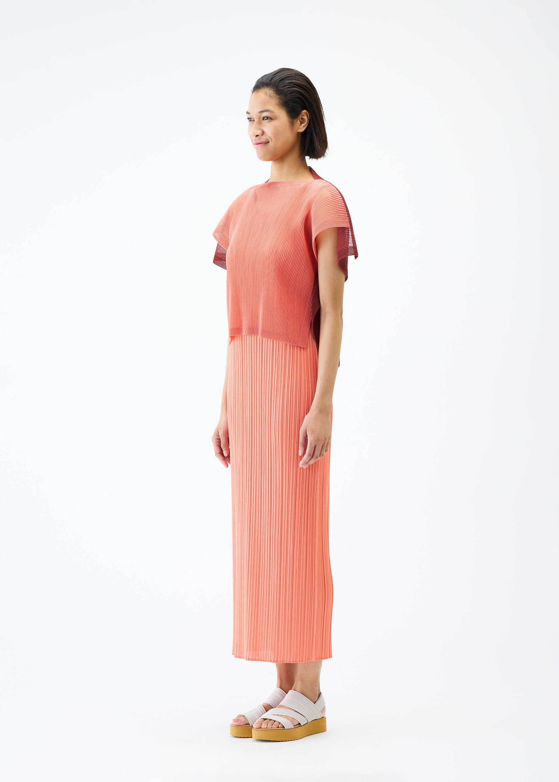 A model wears the PLEATS PLEASE ISSEY MIYAKE SHEER SQUARE top.