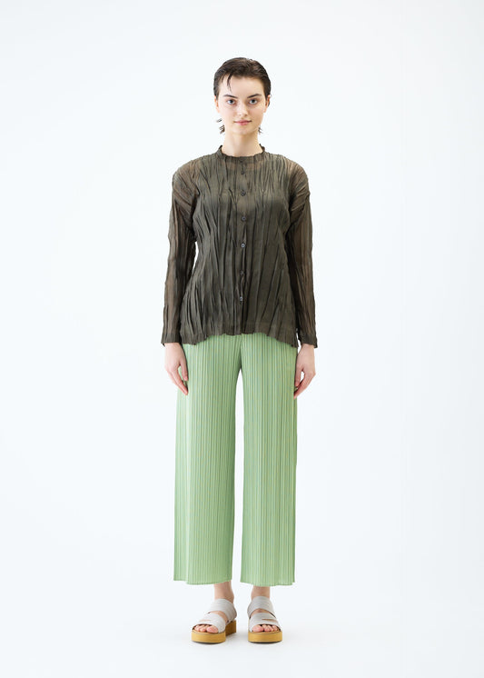 A model wears the PLEATS PLEASE ISSEY MIYAKE SHEER TWIST cardigan.