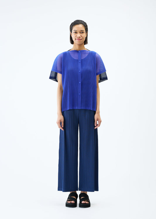 A model wears the PLEATS PLEASE ISSEY MIYAKE SHEER SQUARE cardigan.