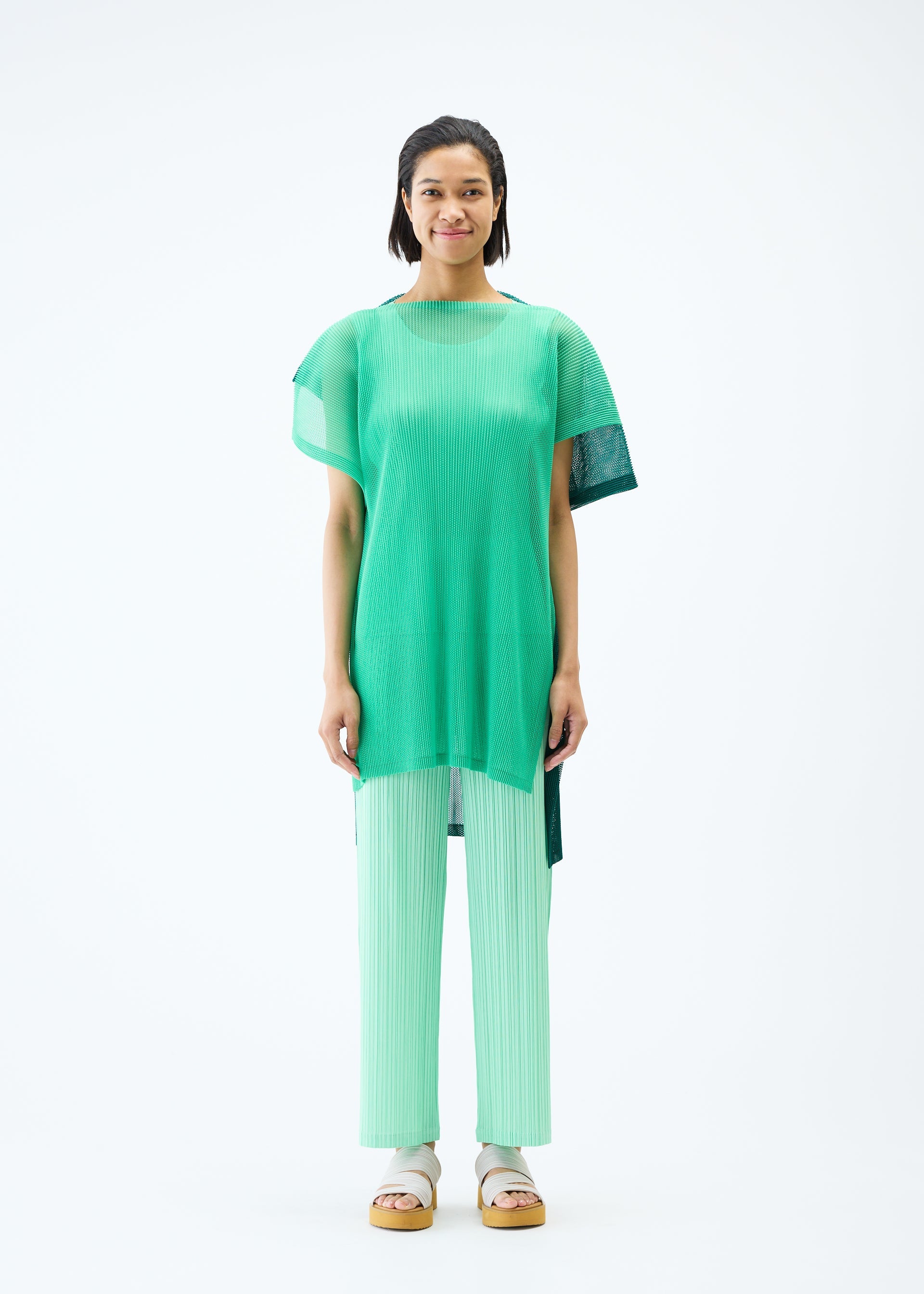 A model wears the PLEATS PLEASE ISSEY MIYAKE SHEER SQUARE tunic.