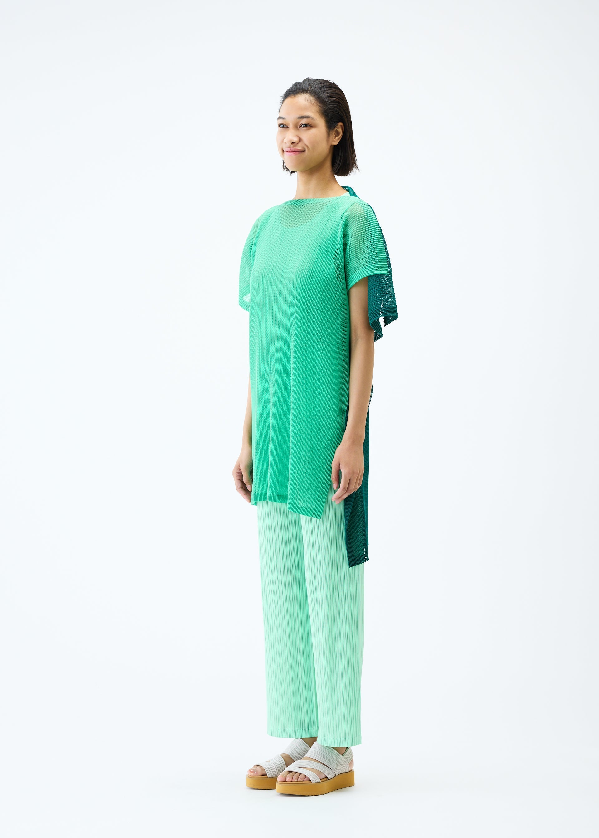 A model wears the PLEATS PLEASE ISSEY MIYAKE SHEER SQUARE tunic.
