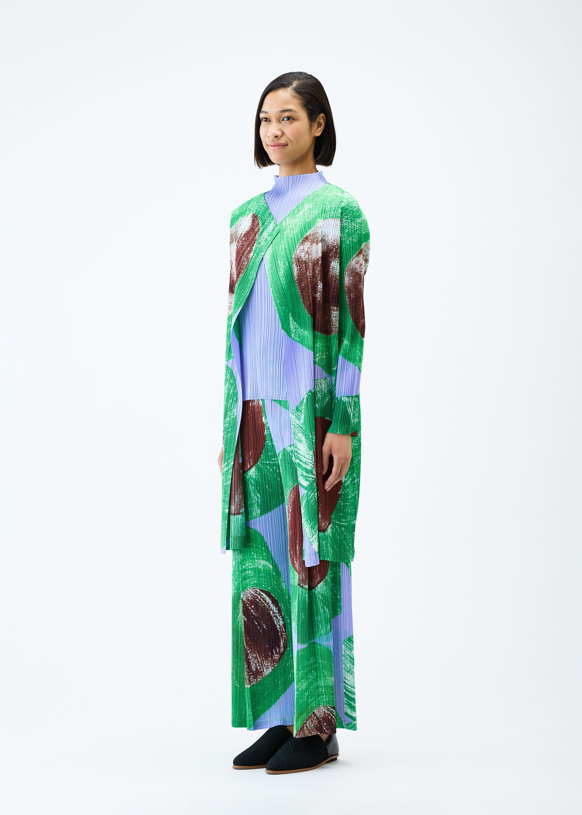 A model wears the PLEATS PLEASE ISSEY MIYAKE BACKLIGHT coat.