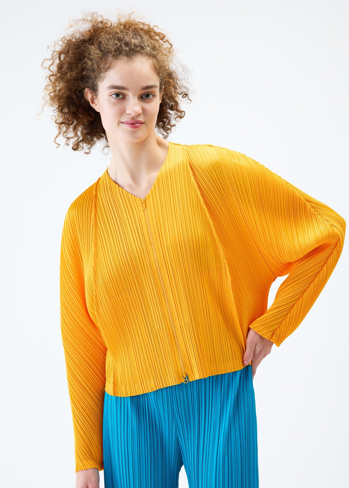 A model wears the PLEATS PLEASE ISSEY MIYAKE LANTERN jacket.