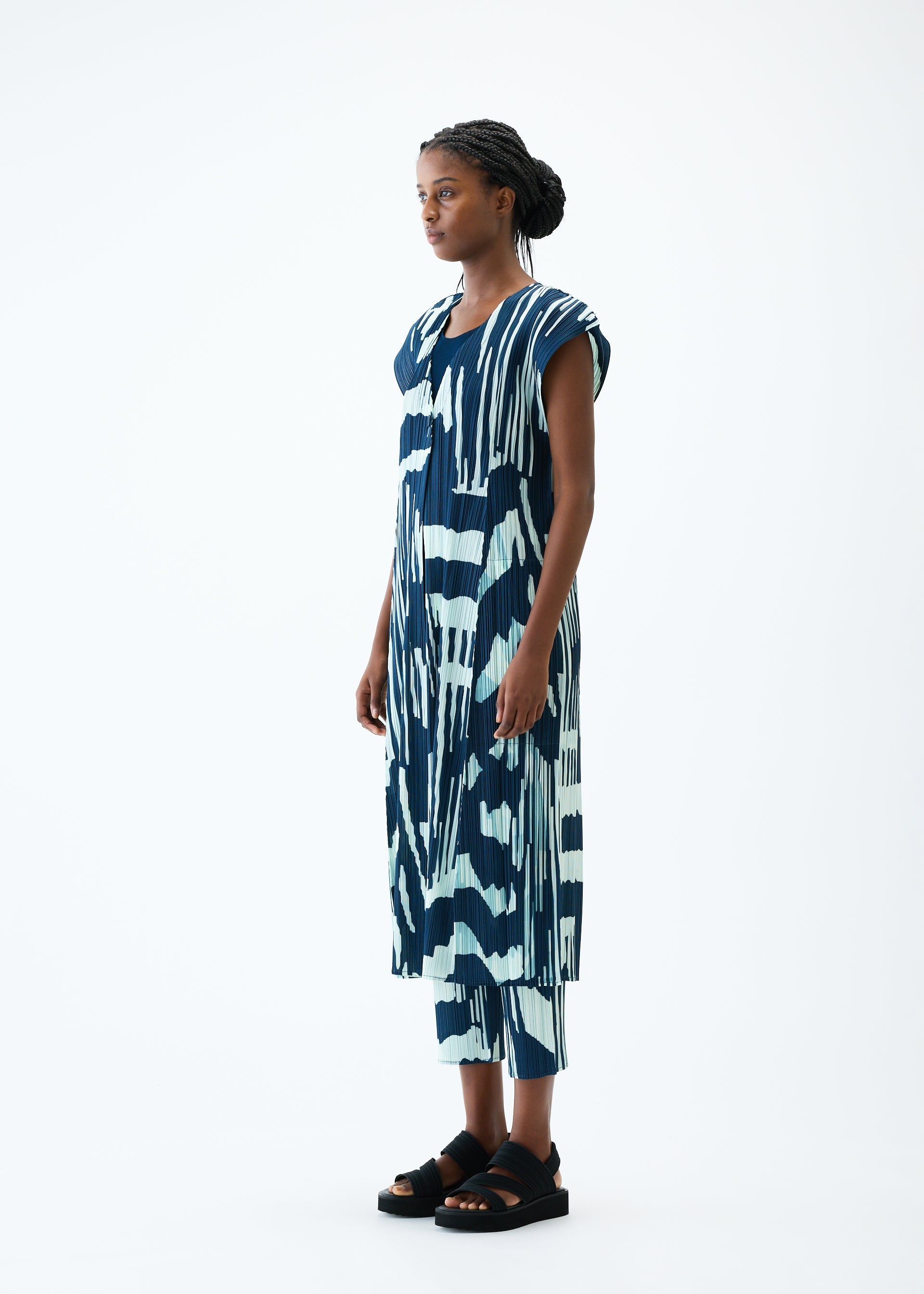 A model wears the PLEATS PLEASE ISSEY MIYAKE REFRACTION vest.