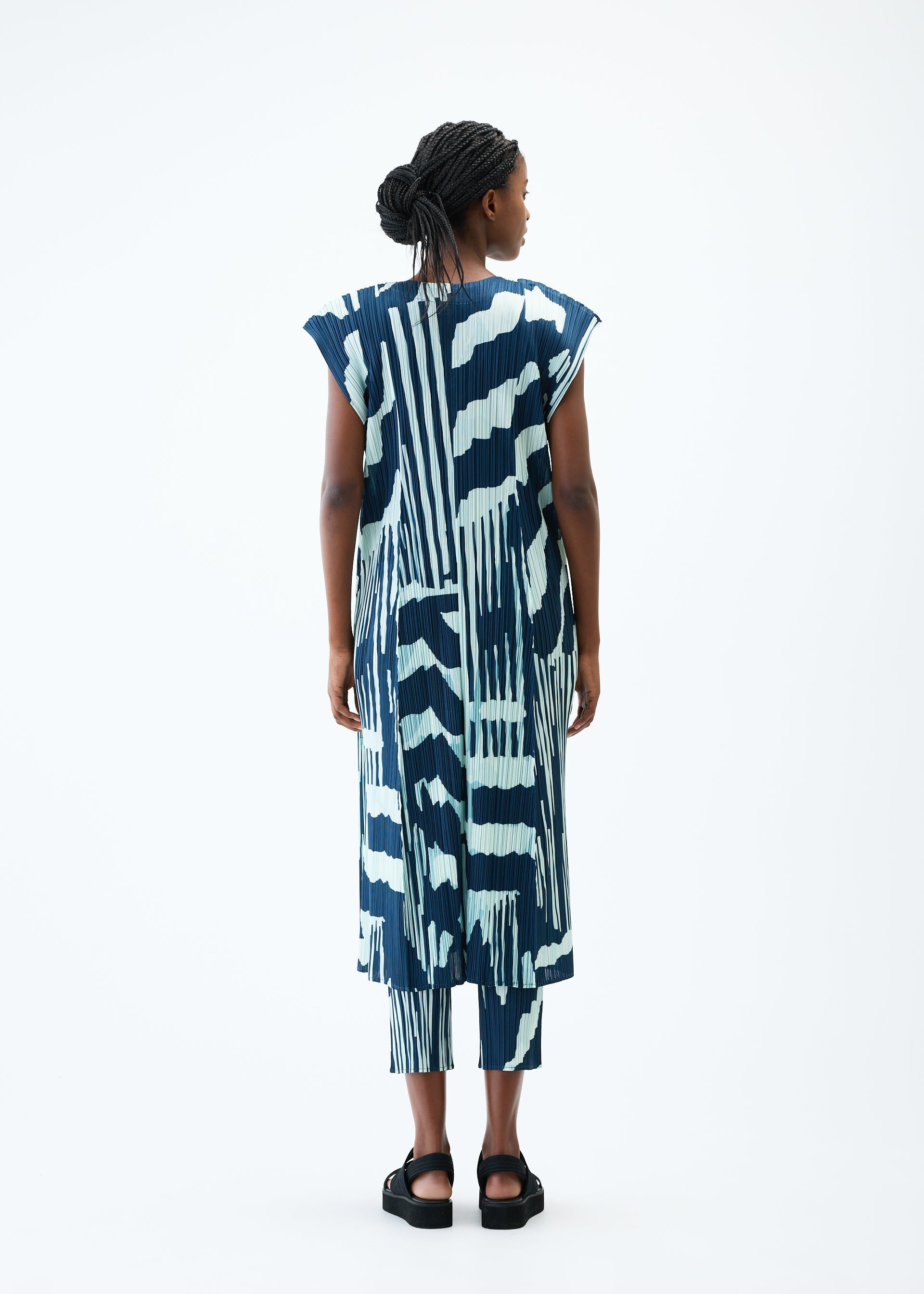A model wears the PLEATS PLEASE ISSEY MIYAKE REFRACTION vest.