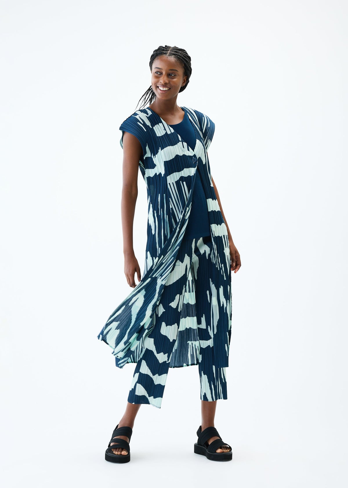 A model wears the PLEATS PLEASE ISSEY MIYAKE REFRACTION vest.