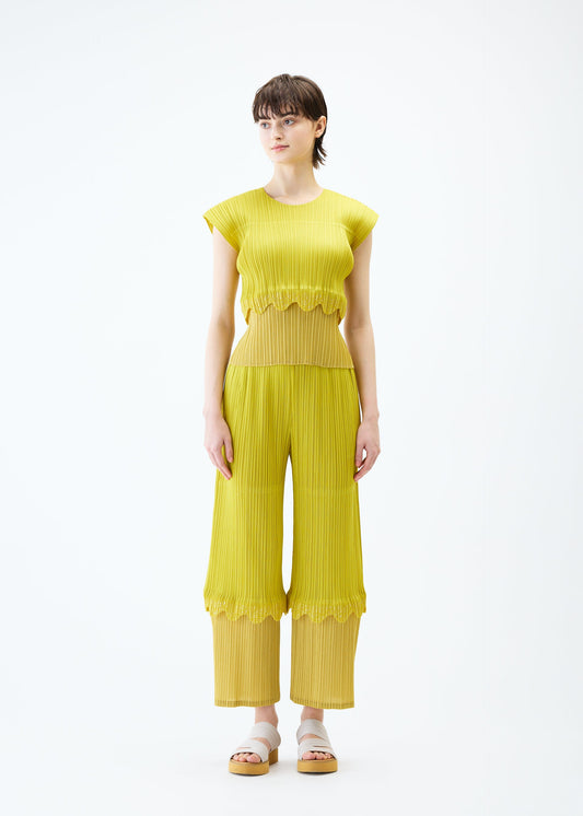 A model wears the PLEATS PLEASE ISSEY MIYAKE TWINKLE trousers.