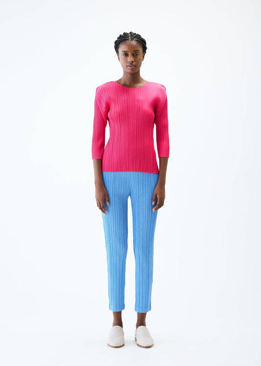 A model wears the PLEATS PLEASE ISSEY MIYAKE THICKER BOTTOMS 2 trousers.