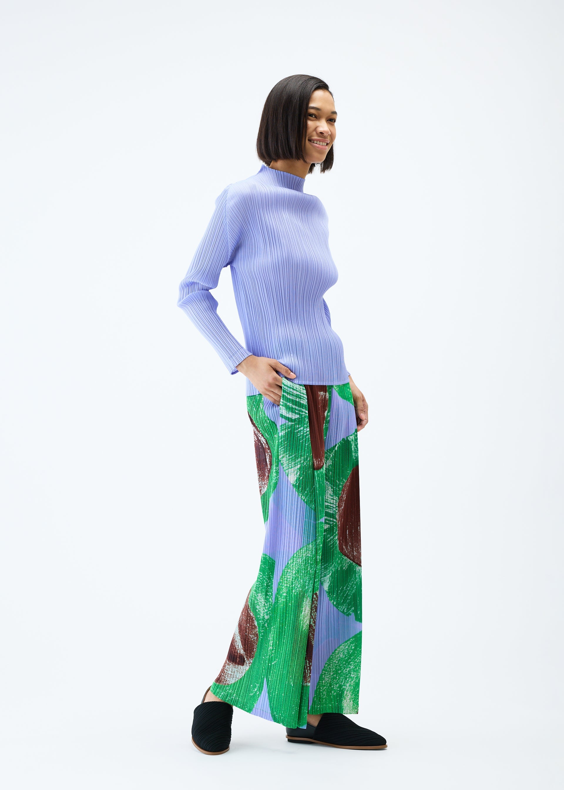 A model wears the PLEATS PLEASE ISSEY MIYAKE BACKLIGHT trousers.