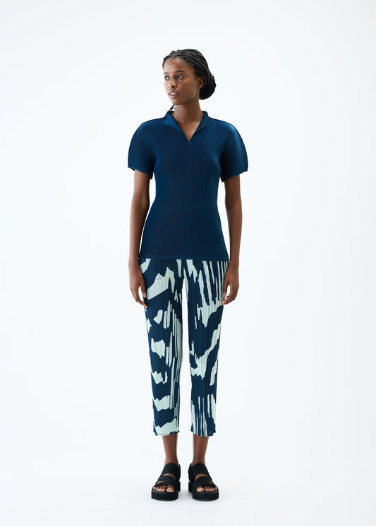 A model wears the PLEATS PLEASE ISSEY MIYAKE REFRACTION trousers.