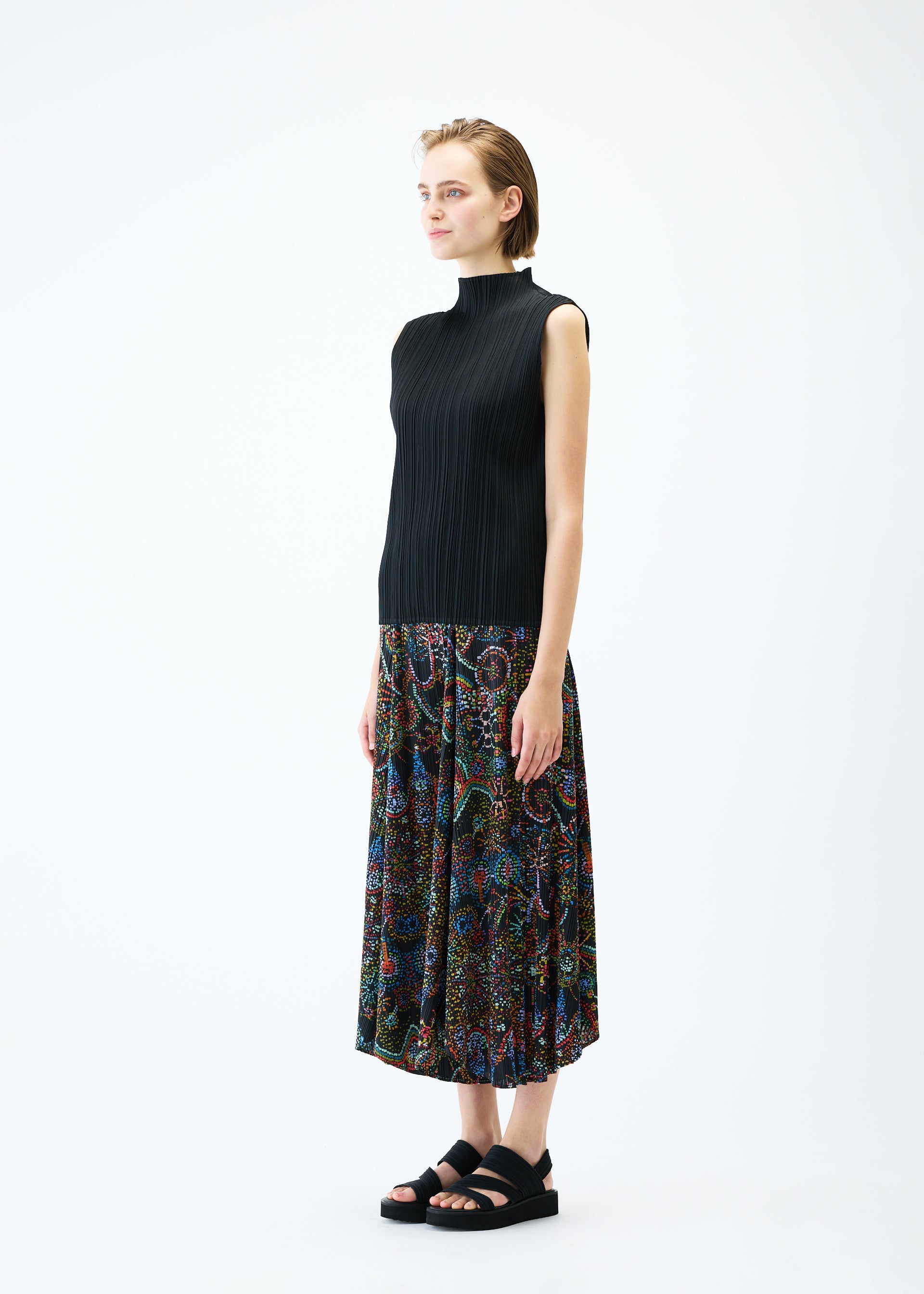 A model wears the PLEATS PLEASE ISSEY MIYAKE LIGHT FESTIVAL trousers.