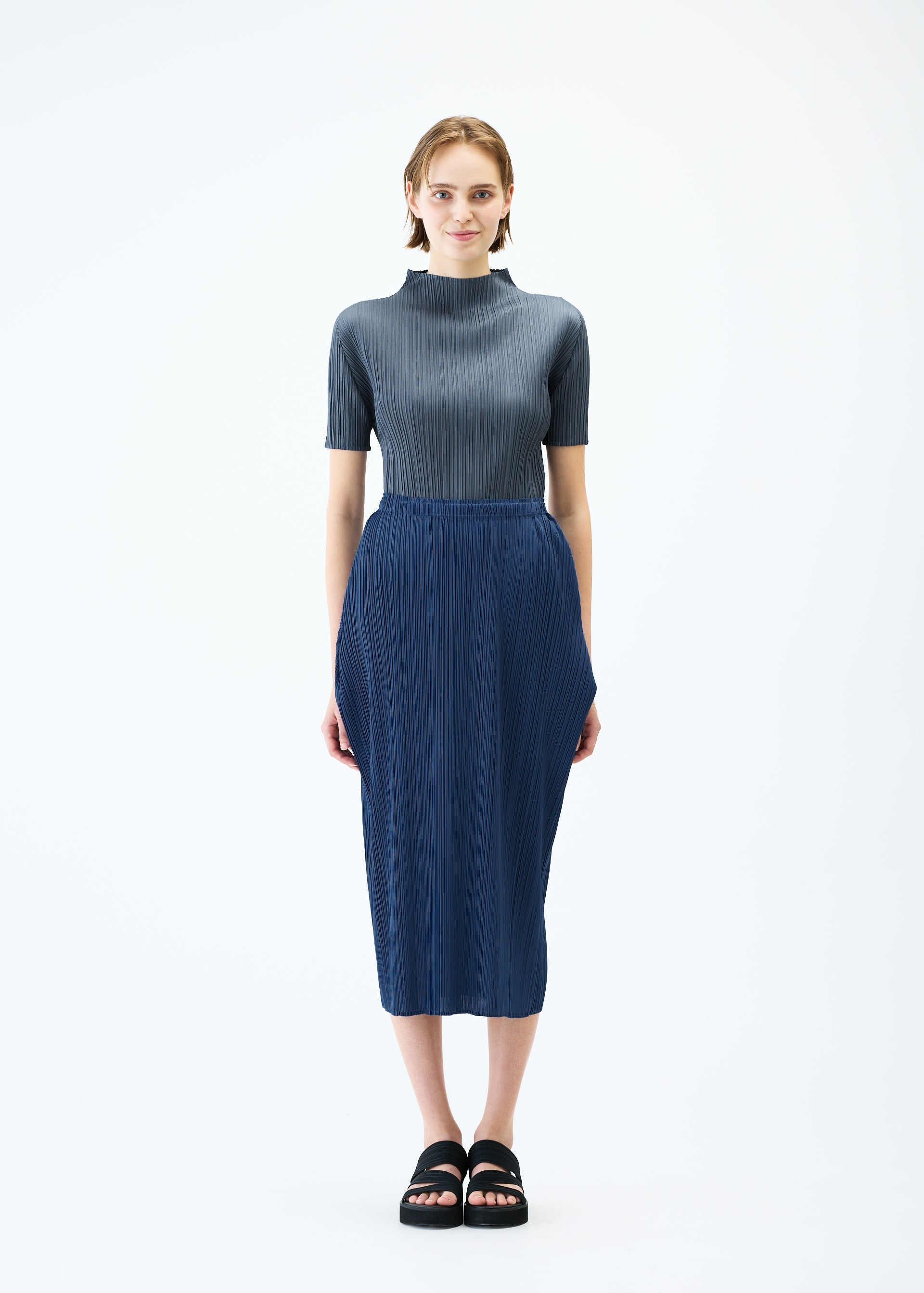 A model wears the PLEATS PLEASE ISSEY MIYAKE LAMP SHADE skirt.