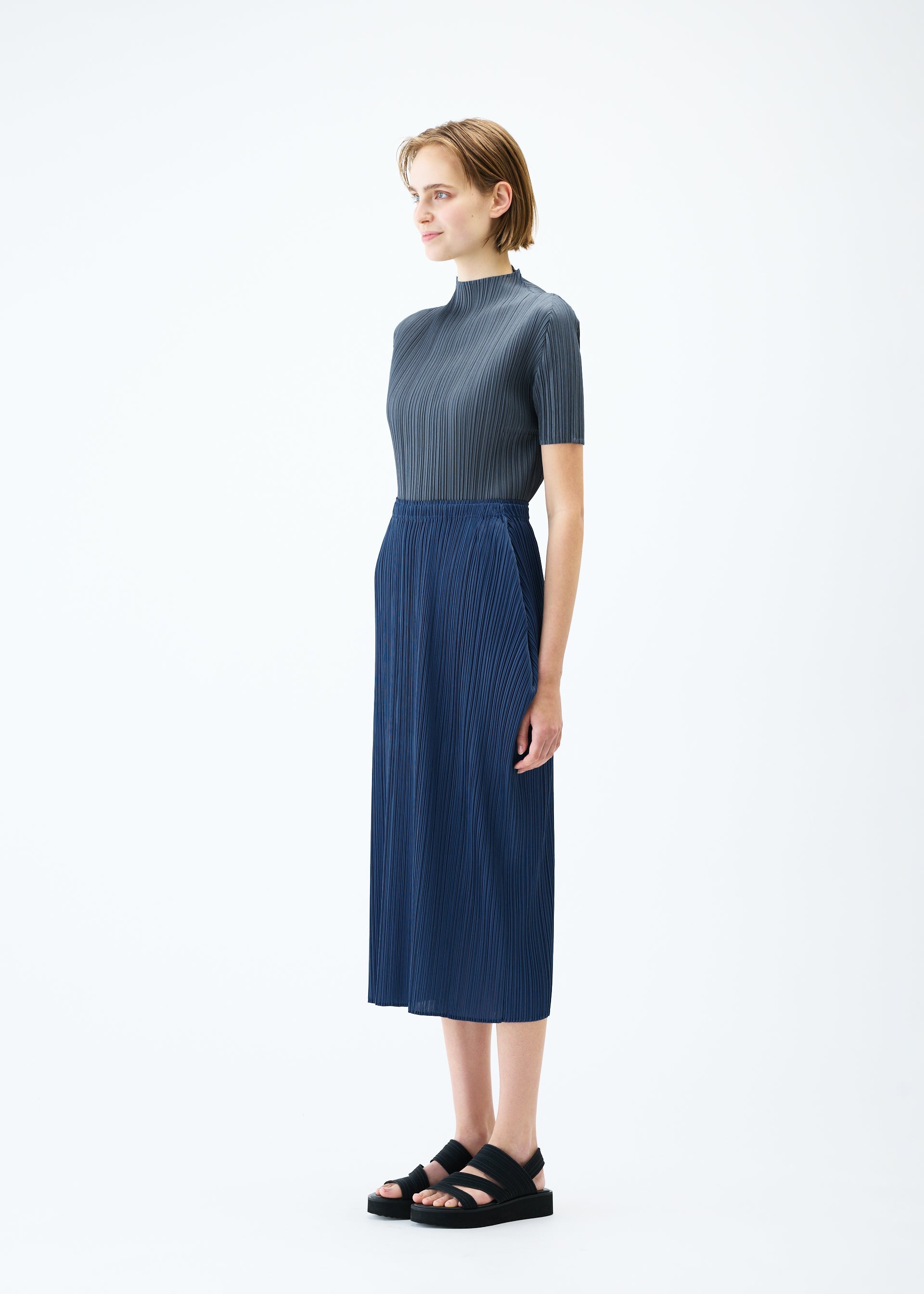 A model wears the PLEATS PLEASE ISSEY MIYAKE LAMP SHADE skirt.
