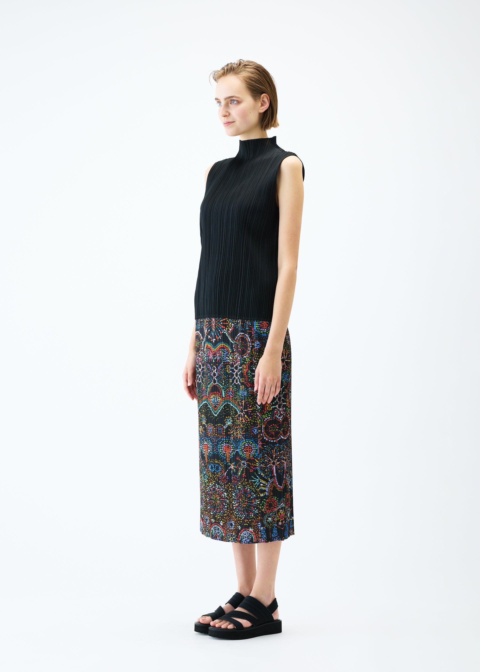 A model wears the PLEATS PLEASE ISSEY MIYAKE LIGHT FESTIVAL skirt.