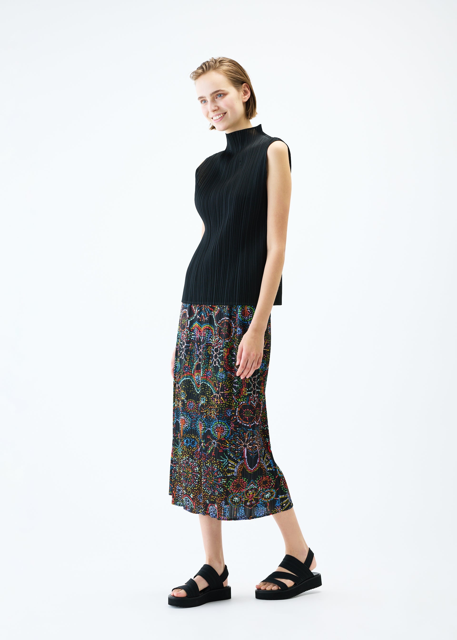 A model wears the PLEATS PLEASE ISSEY MIYAKE LIGHT FESTIVAL skirt.