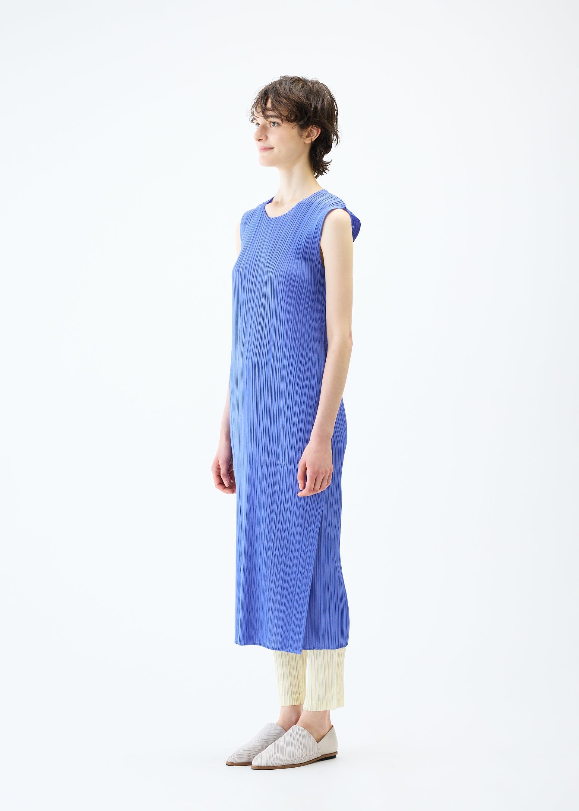 A model wears the PLEATS PLEASE ISSEY MIYAKE MONTHLY COLORS MARCH dress.