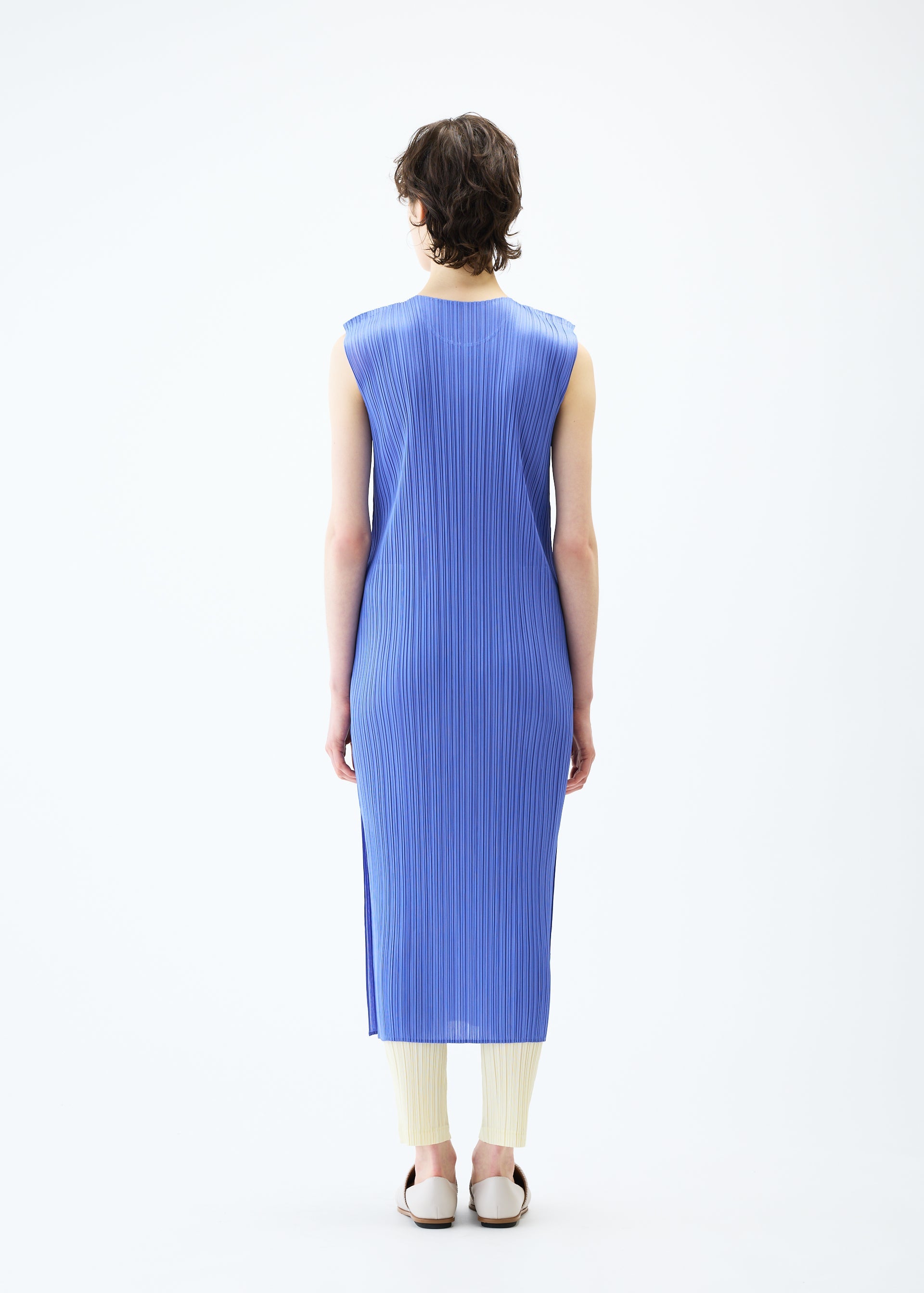 A model wears the PLEATS PLEASE ISSEY MIYAKE MONTHLY COLORS MARCH dress.