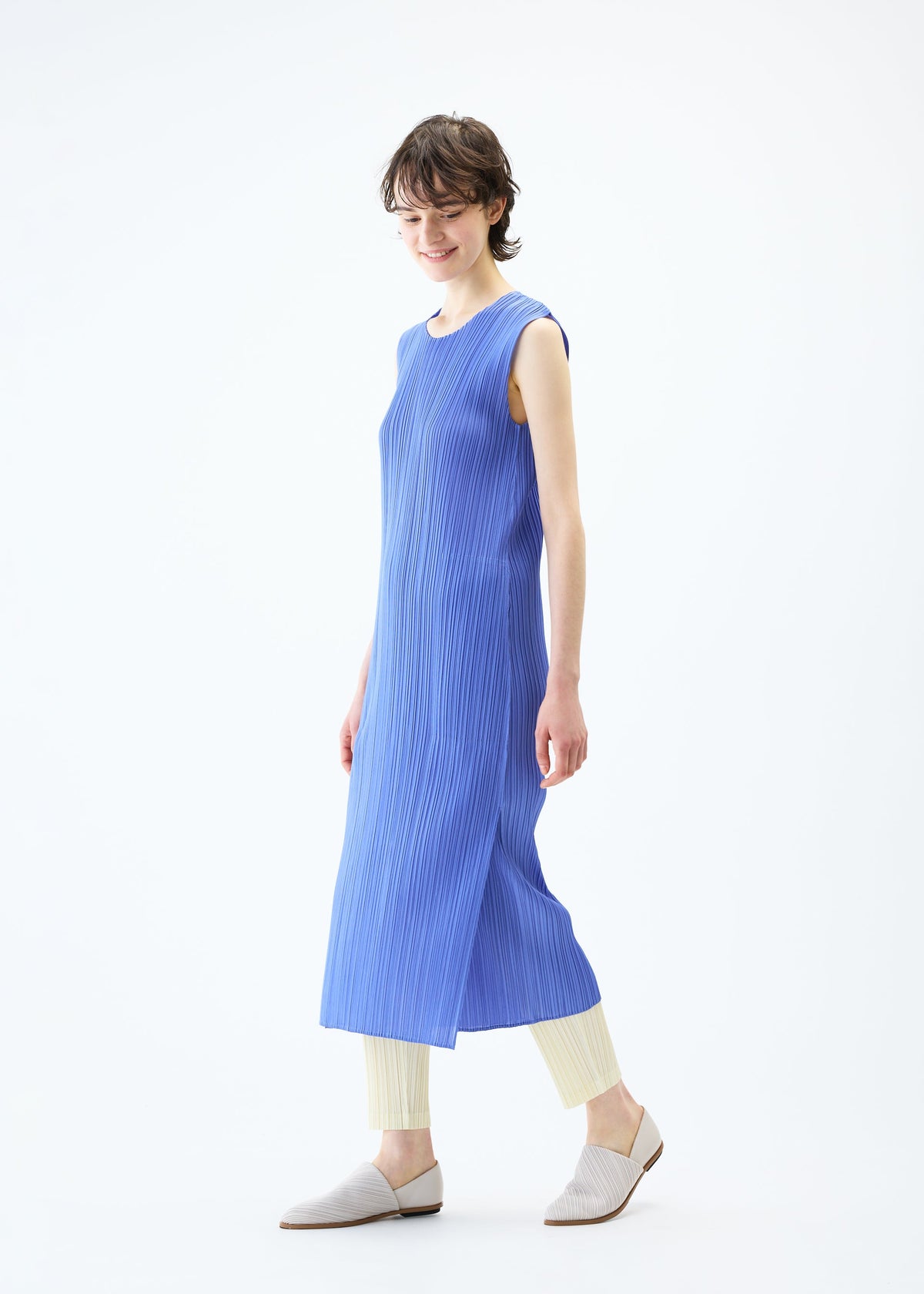 A model wears the PLEATS PLEASE ISSEY MIYAKE MONTHLY COLORS MARCH dress.