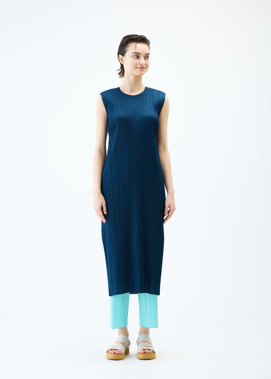 A model wears the PLEATS PLEASE ISSEY MIYAKE MONTHLY COLORS APRIL dress.