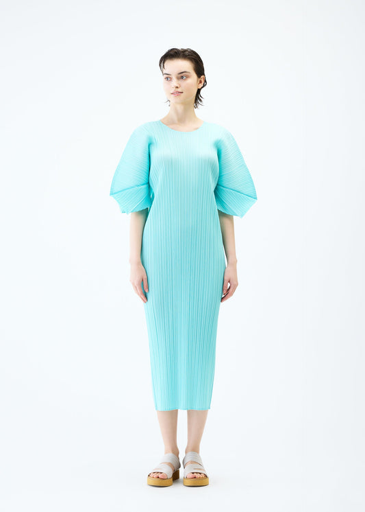 A model wears the PLEATS PLEASE ISSEY MIYAKE MONTHLY COLORS APRIL dress.