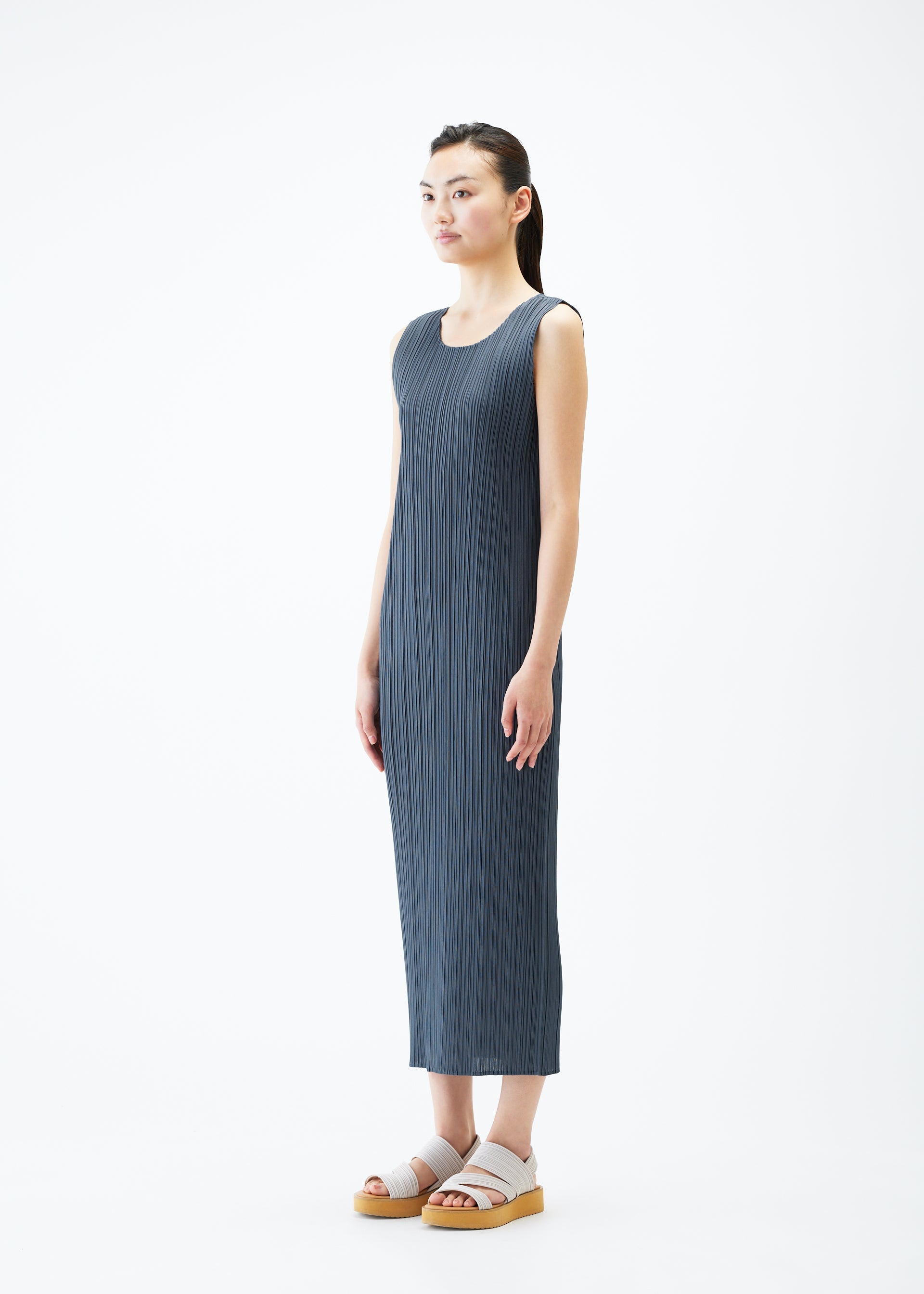 A model wears the PLEATS PLEASE ISSEY MIYAKE MONTHLY COLORS MAY dress.