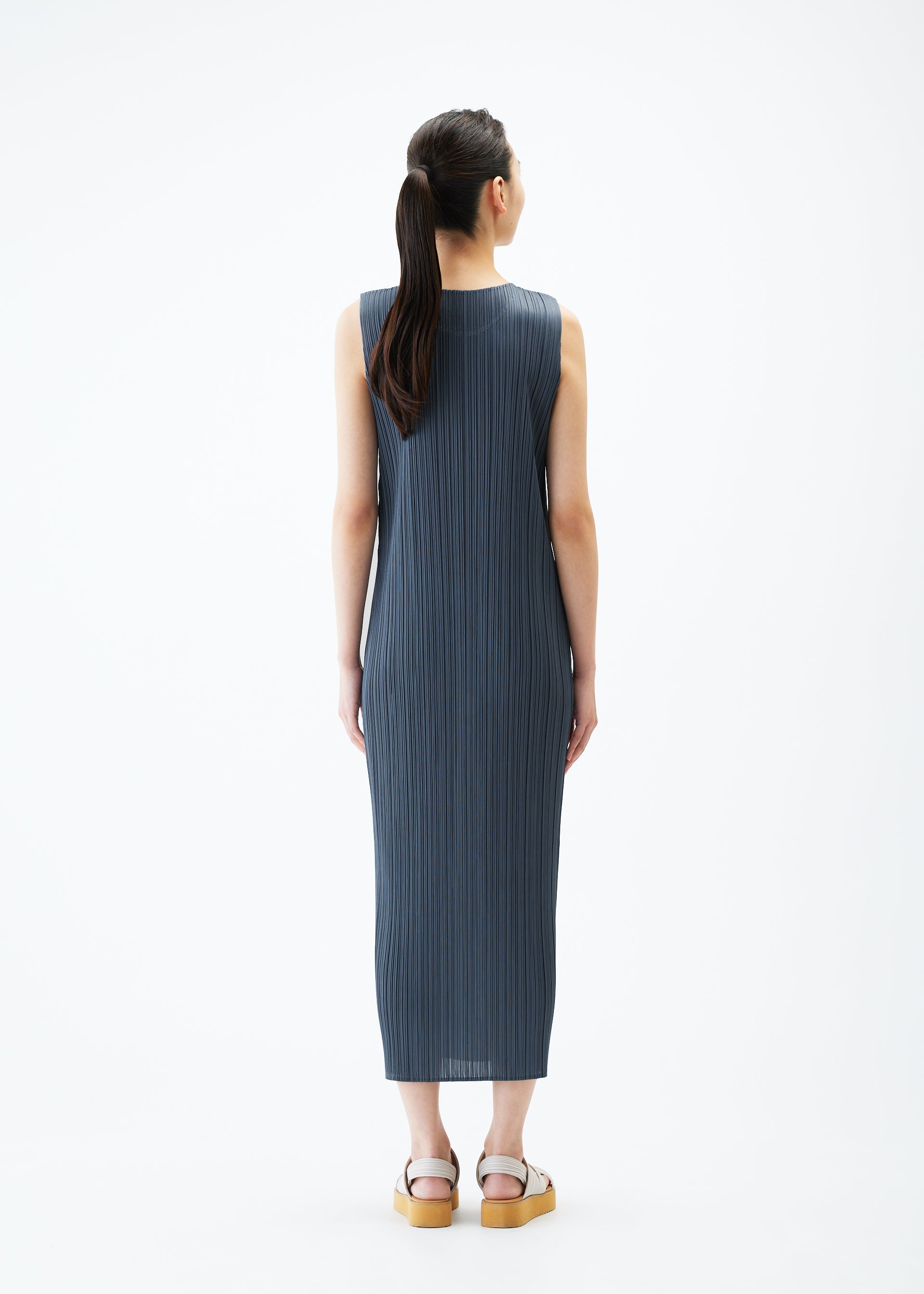 A model wears the PLEATS PLEASE ISSEY MIYAKE MONTHLY COLORS MAY dress.