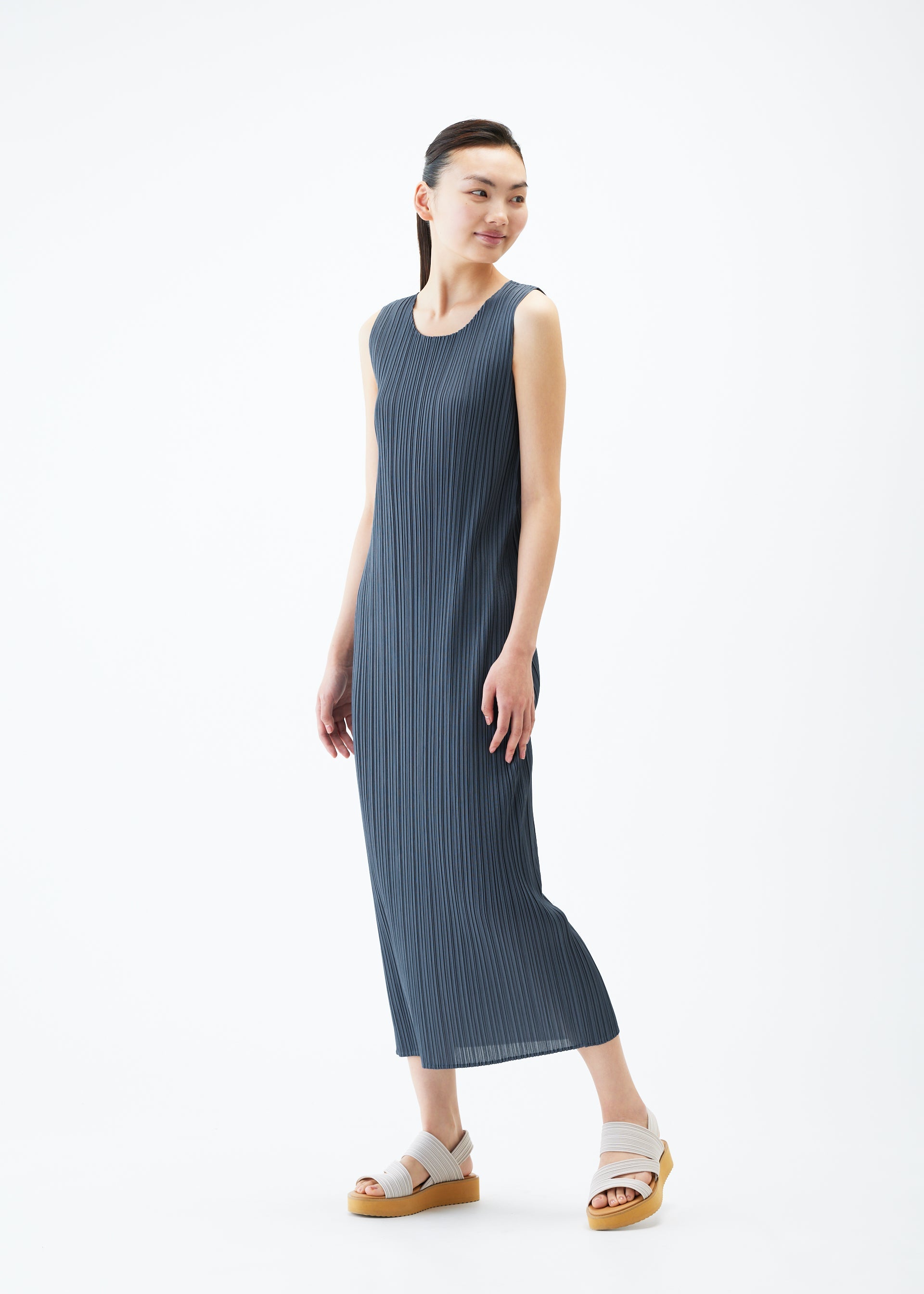 A model wears the PLEATS PLEASE ISSEY MIYAKE MONTHLY COLORS MAY dress.
