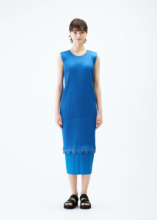 A model wears the PLEATS PLEASE ISSEY MIYAKE TWINKLE dress.