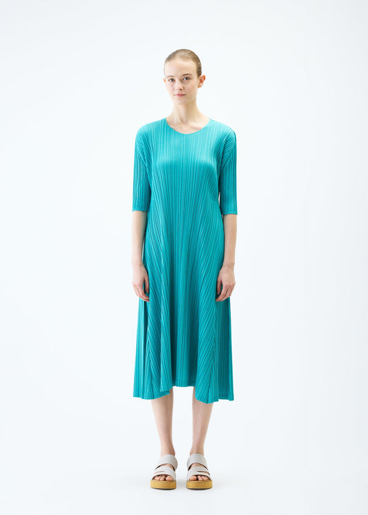A model wears the PLEATS PLEASE ISSEY MIYAKE MELLOW PLEATS dress.
