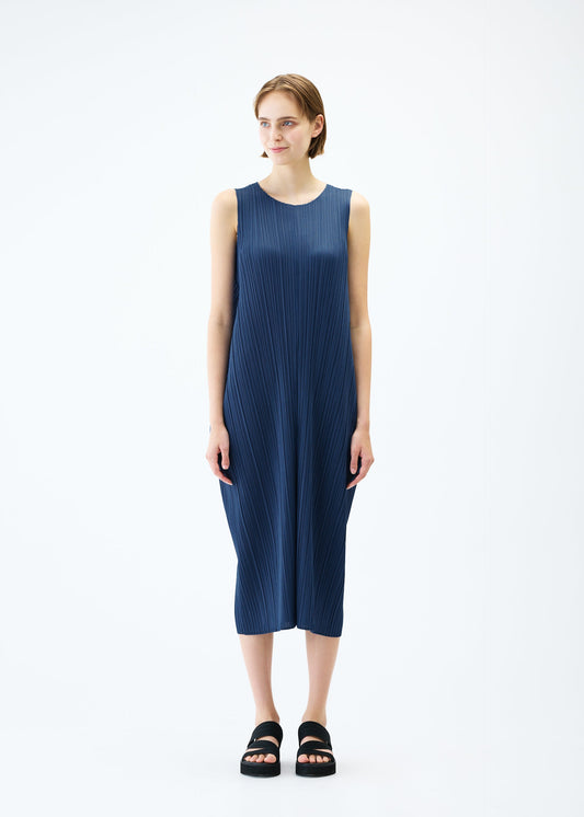 A model wears the PLEATS PLEASE ISSEY MIYAKE LAMP SHADE dress.