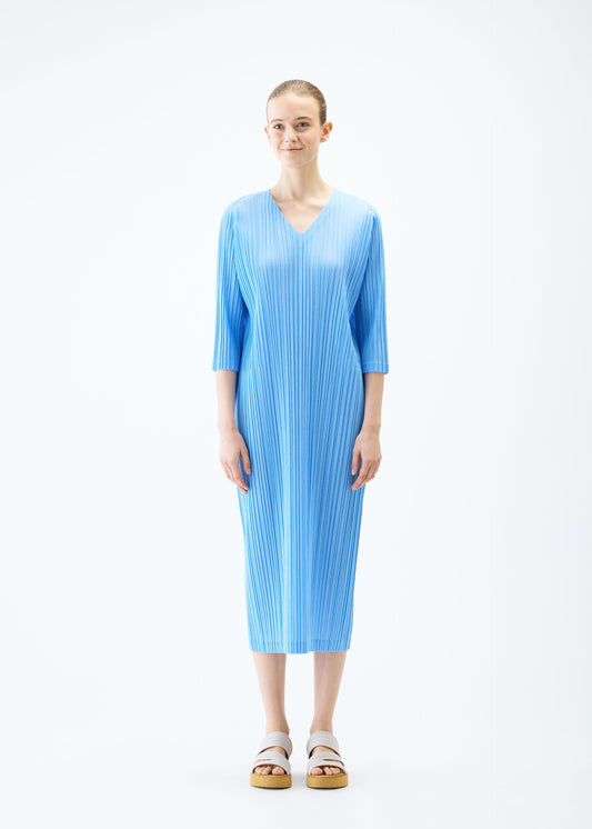 A model wears the PLEATS PLEASE ISSEY MIYAKE RAMIE PLEATS dress.