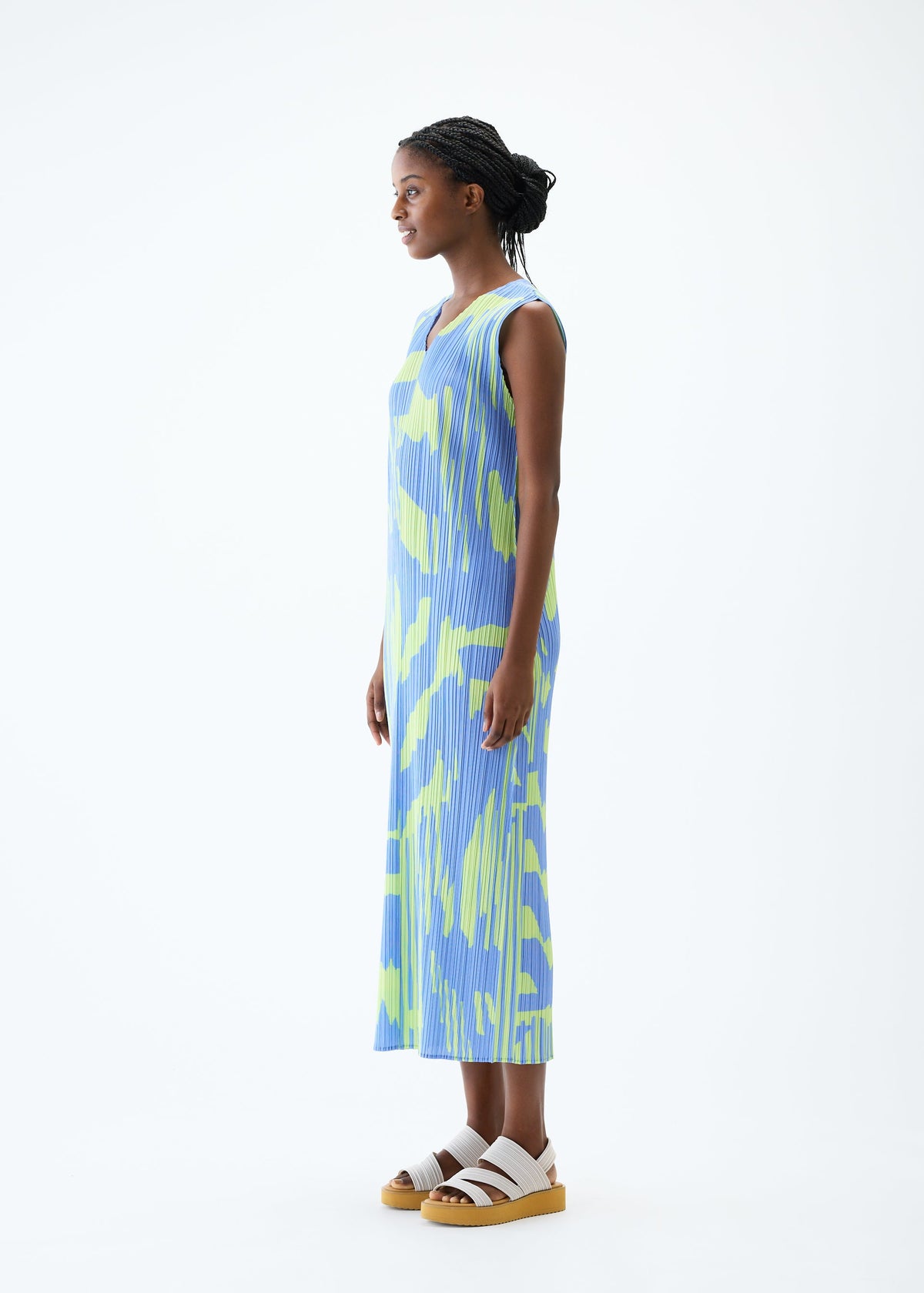 A model wears the PLEATS PLEASE ISSEY MIYAKE REFRACTION dress.