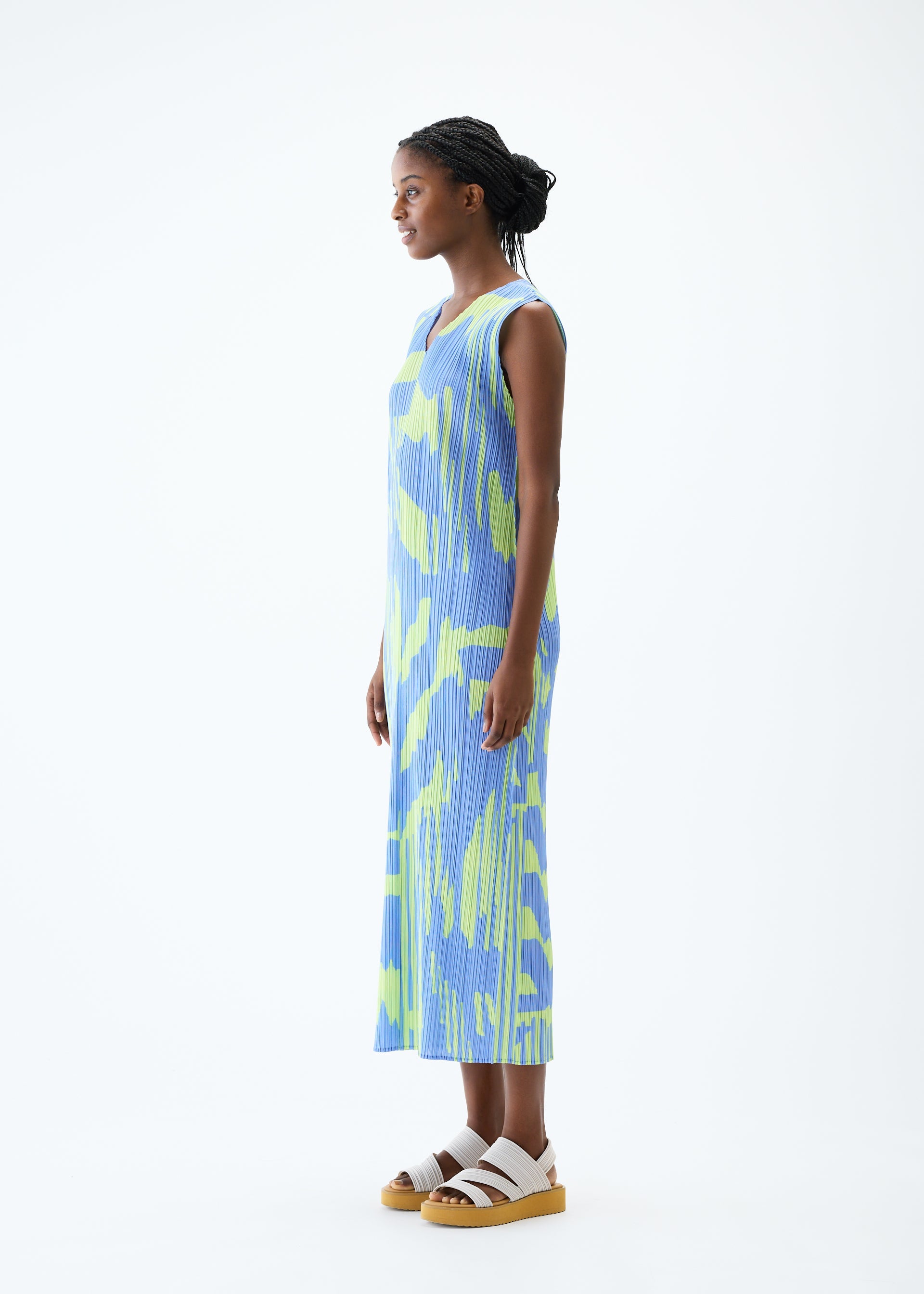 A model wears the PLEATS PLEASE ISSEY MIYAKE REFRACTION dress.