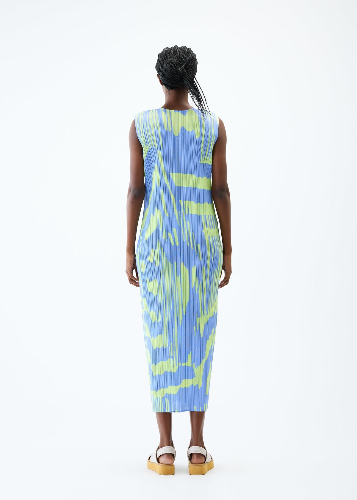 A model wears the PLEATS PLEASE ISSEY MIYAKE REFRACTION dress.