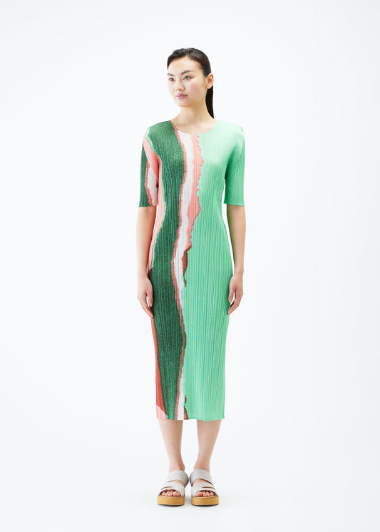 A model wears the PLEATS PLEASE ISSEY MIYAKE GRAINY COLORS dress.