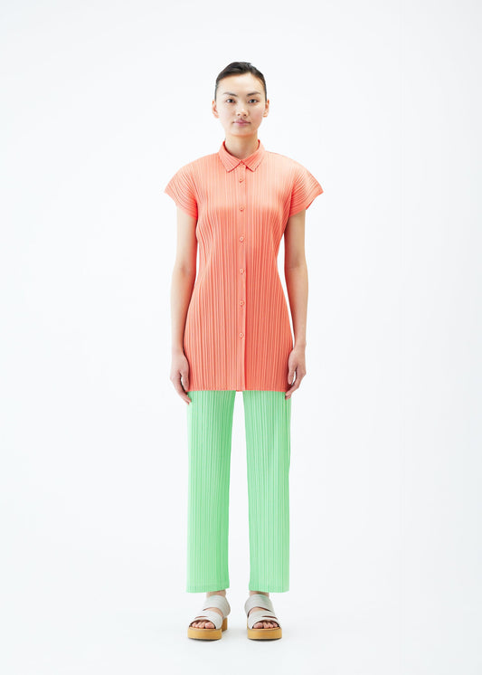 A model wears the PLEATS PLEASE ISSEY MIYAKE MONTHLY COLORS MAY shirt.