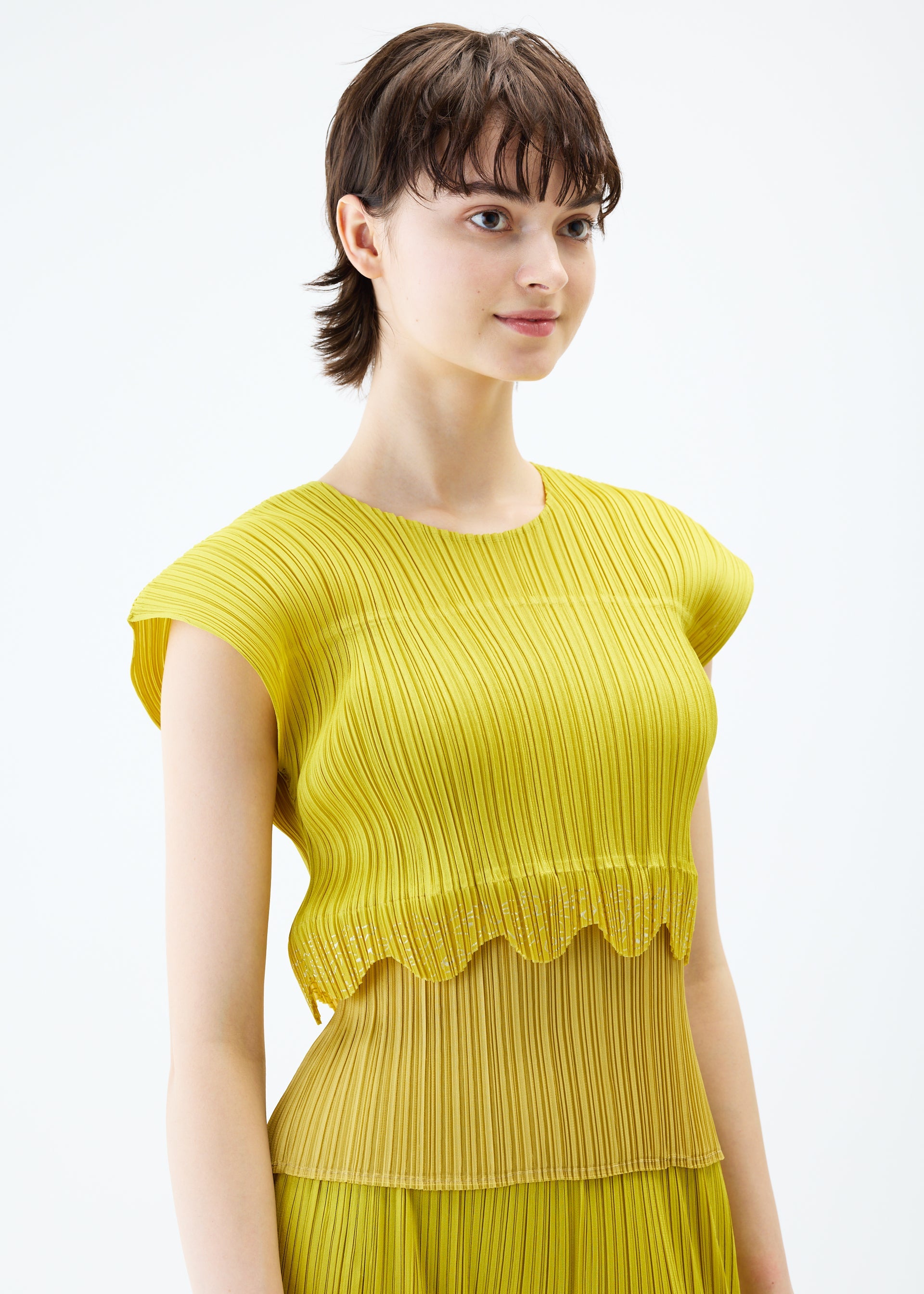 A model wears the PLEATS PLEASE ISSEY MIYAKE TWINKLE top.