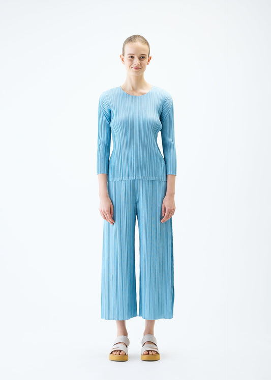 A model wears the PLEATS PLEASE ISSEY MIYAKE MELLOW PLEATS top.