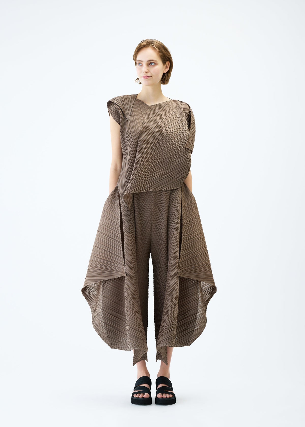 A model wears the PLEATS PLEASE ISSEY MIYAKE FLARE top.