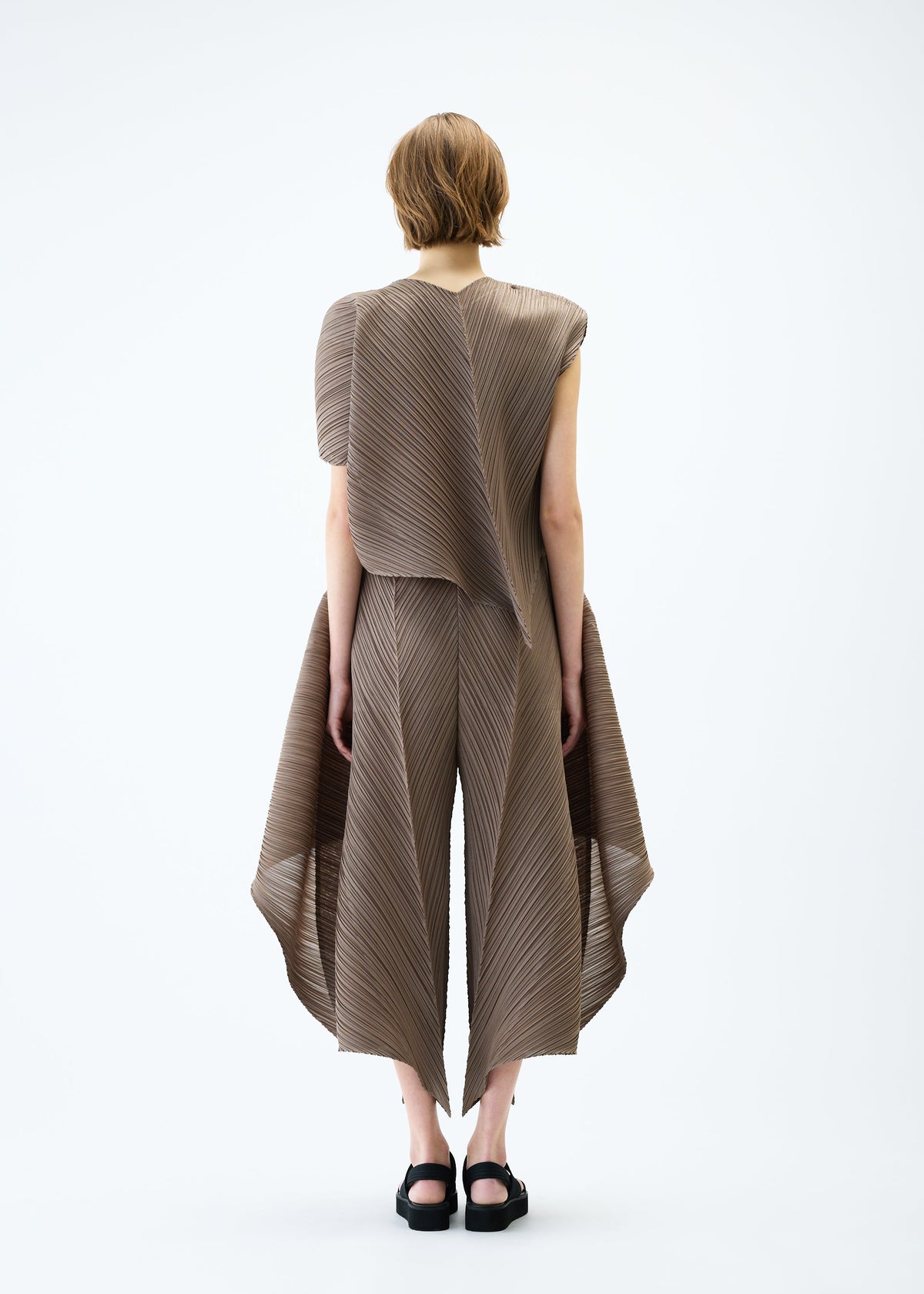 A model wears the PLEATS PLEASE ISSEY MIYAKE FLARE top.